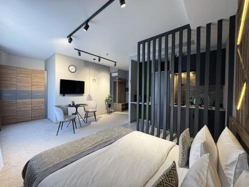 a bedroom with a bed and a table with chairs at HIDE PARK Hotel in Vinnytsya