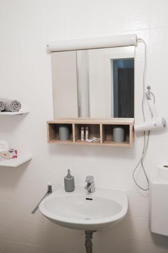 a bathroom with a white sink and a mirror at Haus Dietrich am Red Bull Ring in Spielberg