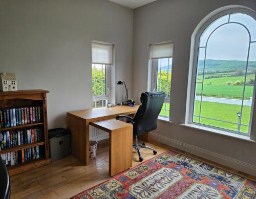 an office with a desk and a chair and a window at Mongalvin in Whitehill
