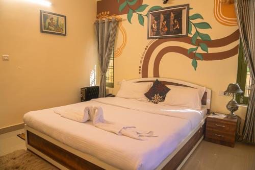 a bedroom with a bed with two dolls on it at THEHIMALAYANLIVING WHISTLING PINES in Mukteswar