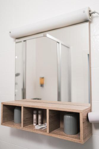 a mirror hanging on a wall in a bathroom at Haus Dietrich am Red Bull Ring in Spielberg