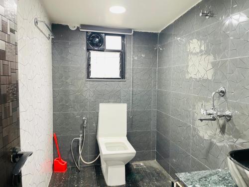 a bathroom with a white toilet and a sink at Hostel Lifespace- Tailor made for working professionals- Luxurious Twin Bungalow with CoWork- only 3 and 4 share Rooms in Pune