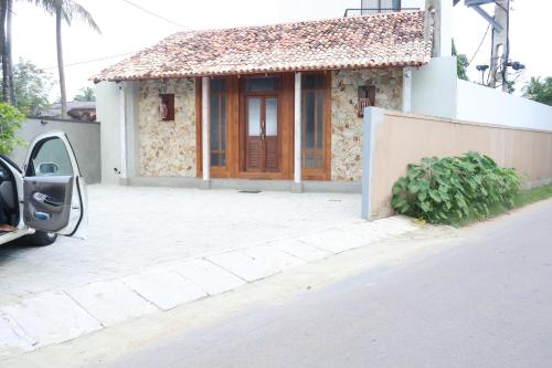 a small house with a door on a street at Handagedara Resort & Spa in Mirissa