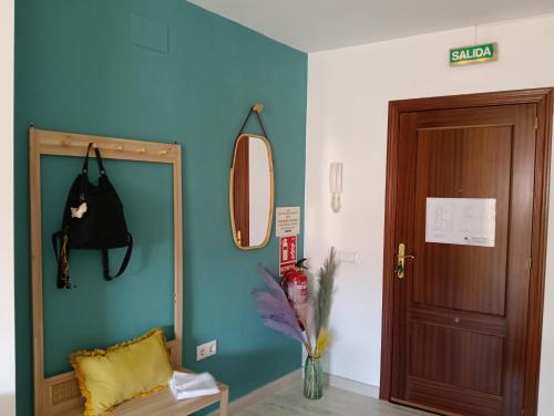a room with a blue wall and a mirror at Apartamento La Bella Vista ATBA00361 in Zafra