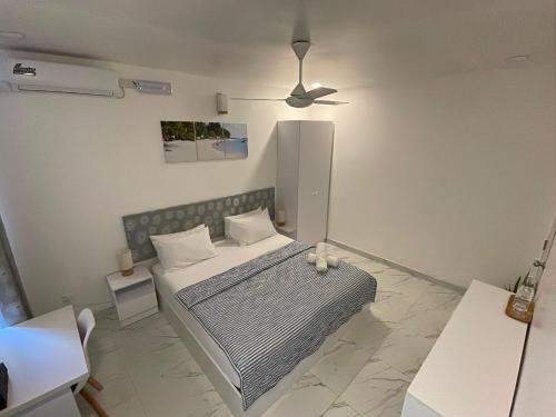 a bedroom with a bed and a ceiling at Empyrean Stay, Maldives in Thulusdhoo