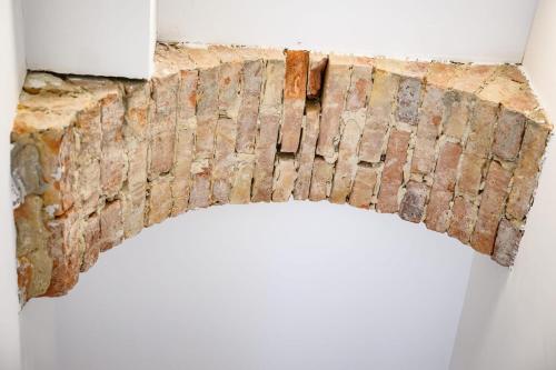 a brick wall hanging on a wall in a room at Cozy Lofts Next To Berliner Wall in Berlin