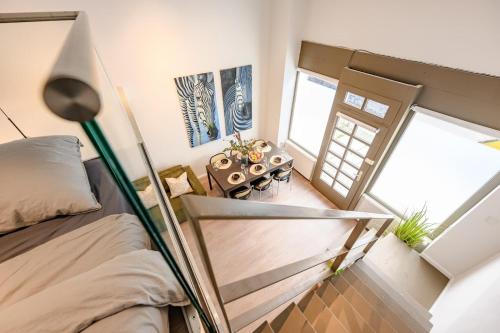 a small bedroom with a bed and a window at Cozy Lofts Next To Berliner Wall in Berlin