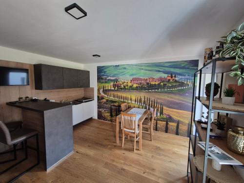 a kitchen with a painting on the wall at RITTERTAL Altmünster Traunsee Apartment in Altmünster