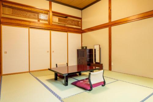 a dining room with a table and chairs at Fujisan Ryokan in Hanamaki