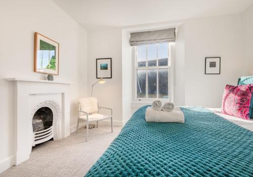 a bedroom with a bed and a fireplace at Luxury Apartment in Bowness in Bowness-on-Windermere
