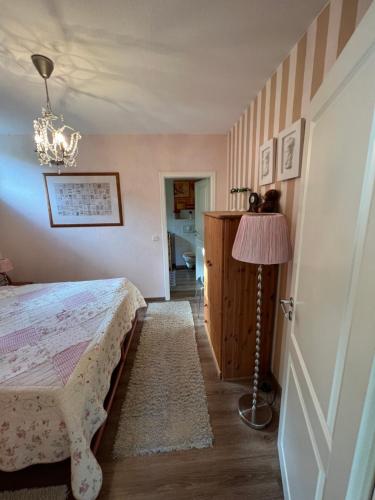 a bedroom with a bed and a lamp at Apartment Vis-a-vis in Wernigerode