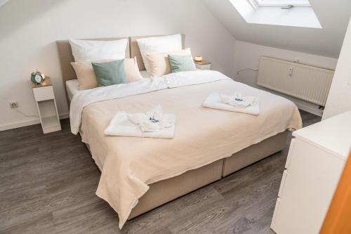 a bedroom with a large bed with towels on it at krönchen zwei in Siegen