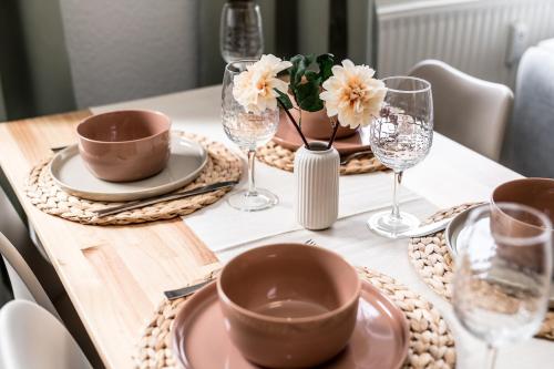 a table with plates and wine glasses on it at krönchen zwei in Siegen