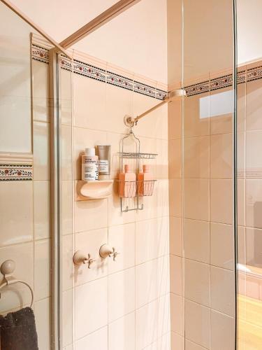 a bathroom with a shower with a glass shower stall at Bush Retreat on the Bay in McCrae