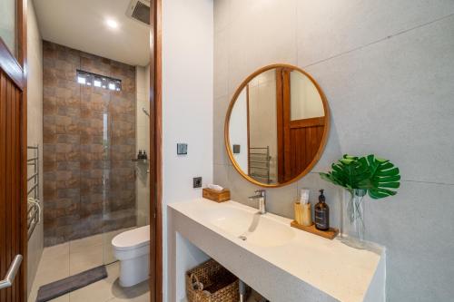 a bathroom with a sink and a mirror at Exquisite New Villa with Unmatched Amazing Views, Huge Pool - 4 Elegant Bedrooms! in Canggu