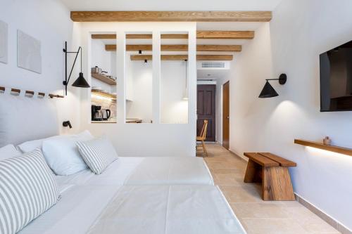 a living room with a couch and a tv at Aegean Houses in Kos Town