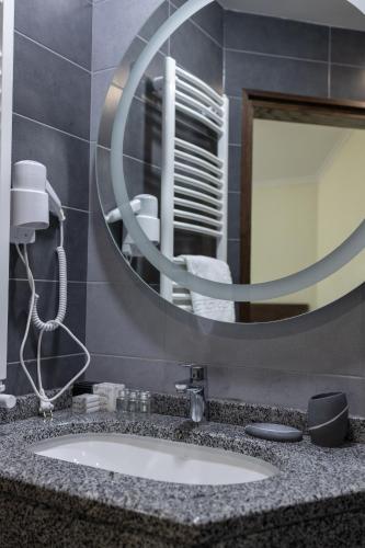 a bathroom with a sink and a mirror at Синевирський Перевал in Synevyr