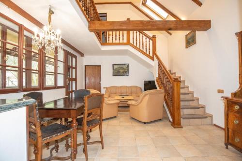 a dining room and living room with a table and chairs at Resort U Jelena in Křivoklát
