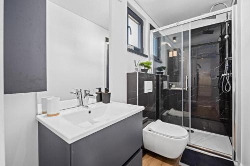 a bathroom with a sink and a toilet and a shower at Sea view Anika by Vellaris, Luxury Mobile Home in Mali Lošinj