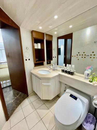 a bathroom with a white toilet and a sink at 所在行旅2館-渡咕所在 UrbanAbode2-DUGU in Taipei