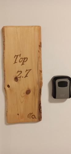 a wooden cutting board with the word top written on it at RITTERTAL Altmünster Traunsee Apartment in Altmünster