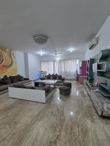 a large living room with couches and a table at Elite stays viman nagar in Pune