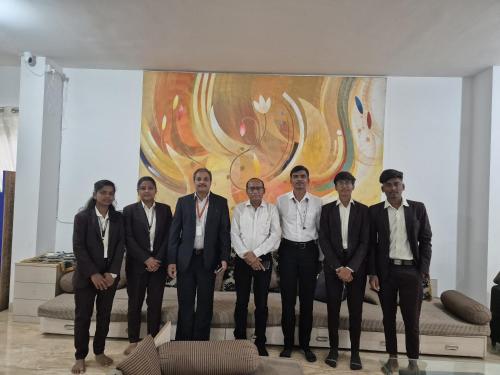 a group of men standing in front of a painting at Elite stays viman nagar in Pune
