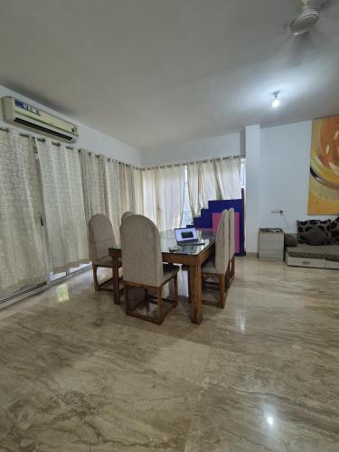 a dining room with a table and chairs in a room at Elite stays viman nagar in Pune