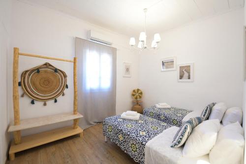 a small bedroom with a bed and a window at MZ Mykonos Rock in Pánormos