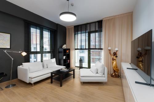 a living room with white furniture and windows at La Sirene 1, Port De La Mer - Mint Stay in Dubai