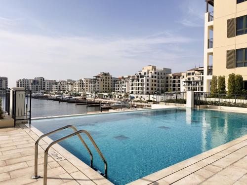 a large swimming pool on top of a building at La Sirene 1, Port De La Mer - Mint Stay in Dubai