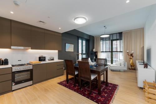 a kitchen with a table and a living room at La Sirene 1, Port De La Mer - Mint Stay in Dubai