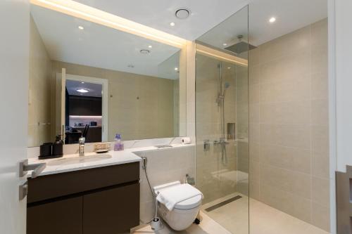 a bathroom with a toilet and a sink and a shower at La Sirene 1, Port De La Mer - Mint Stay in Dubai