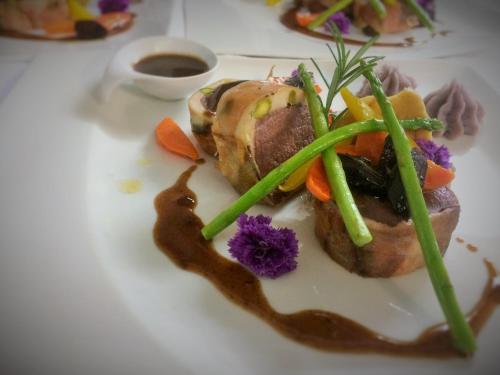 a plate of food with vegetables and sauce on it at Hotel Tauernstern in Winklern