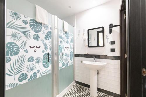 a bathroom with a shower and a sink at U-Sense For You Hostel Sevilla in Seville