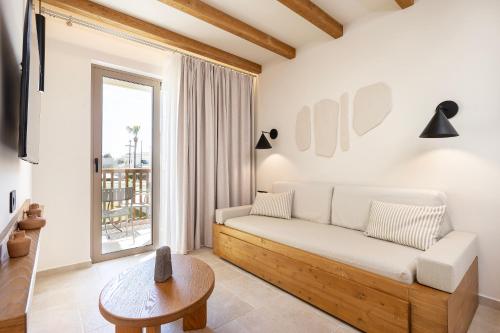 a living room with a couch and a table at Aegean Houses in Kos Town
