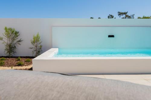 a bed with a swimming pool on top of it at Pestana Comporta Village Residences in Comporta