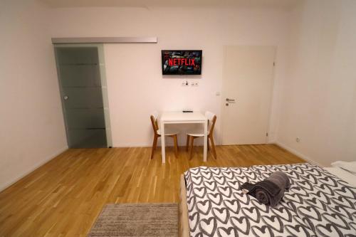 a room with a table and a table and a bed at Diamond Home Apartments in Vienna
