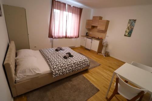 a small bedroom with a bed and a table at Diamond Home Apartments in Vienna