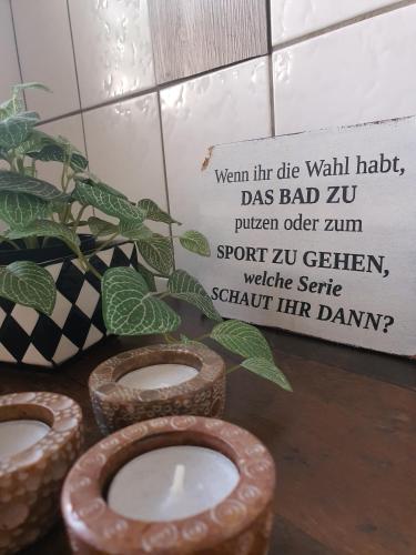 a bathroom with a toilet and a plant and a sign at PIER19Farmhouse in Emden