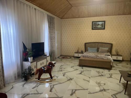 a living room with a dog on a surfboard in the middle of a bedroom at Sheraton Luxury Villa in Baku
