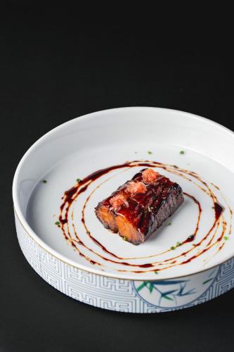 a piece of food on a plate with sauce at The Blue by Just Inn in Taipei