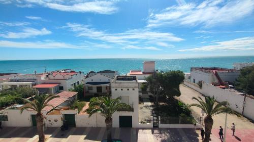 a view of the ocean from a building with palm trees at Playa Paradis III - Primera linea de playa in Moncófar