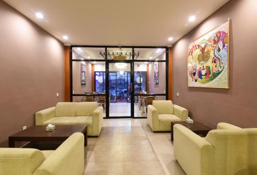 a waiting room with couches and chairs and a table at Hotel Harmony in Kathmandu