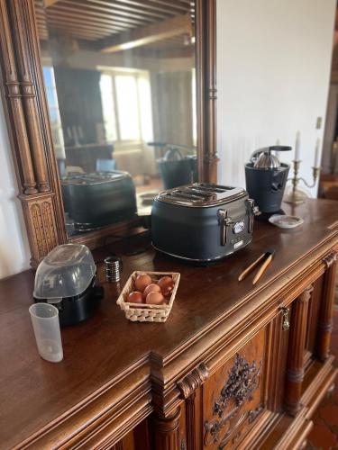 a table with a mirror and a bowl of eggs at Château Philip in Saint-Genest-Lerpt
