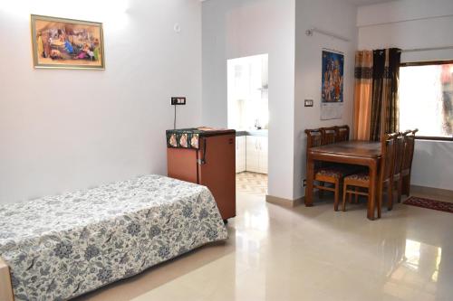 a bedroom with a bed and a table and a desk at Sharma in Shimla