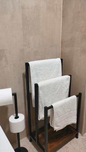 a towel rack with towels on it in a bathroom at Playa Paradis III - Primera linea de playa in Moncófar