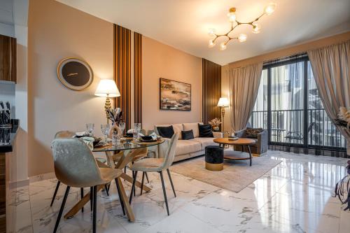 a living room with a table and a couch at Private Beach 1BR-Yacht Club-Work Space-Pool-Gym in Ras al Khaimah