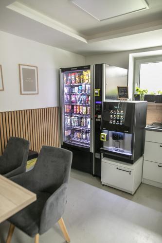 a room with a refrigerator with drinks in it at Hotel U Kociana in Trojanovice