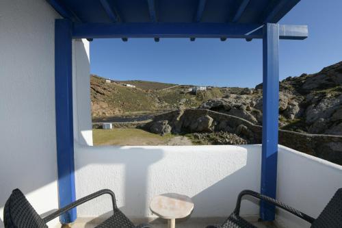 a view from a room with chairs and a window at MZ Mykonos Rock in Pánormos
